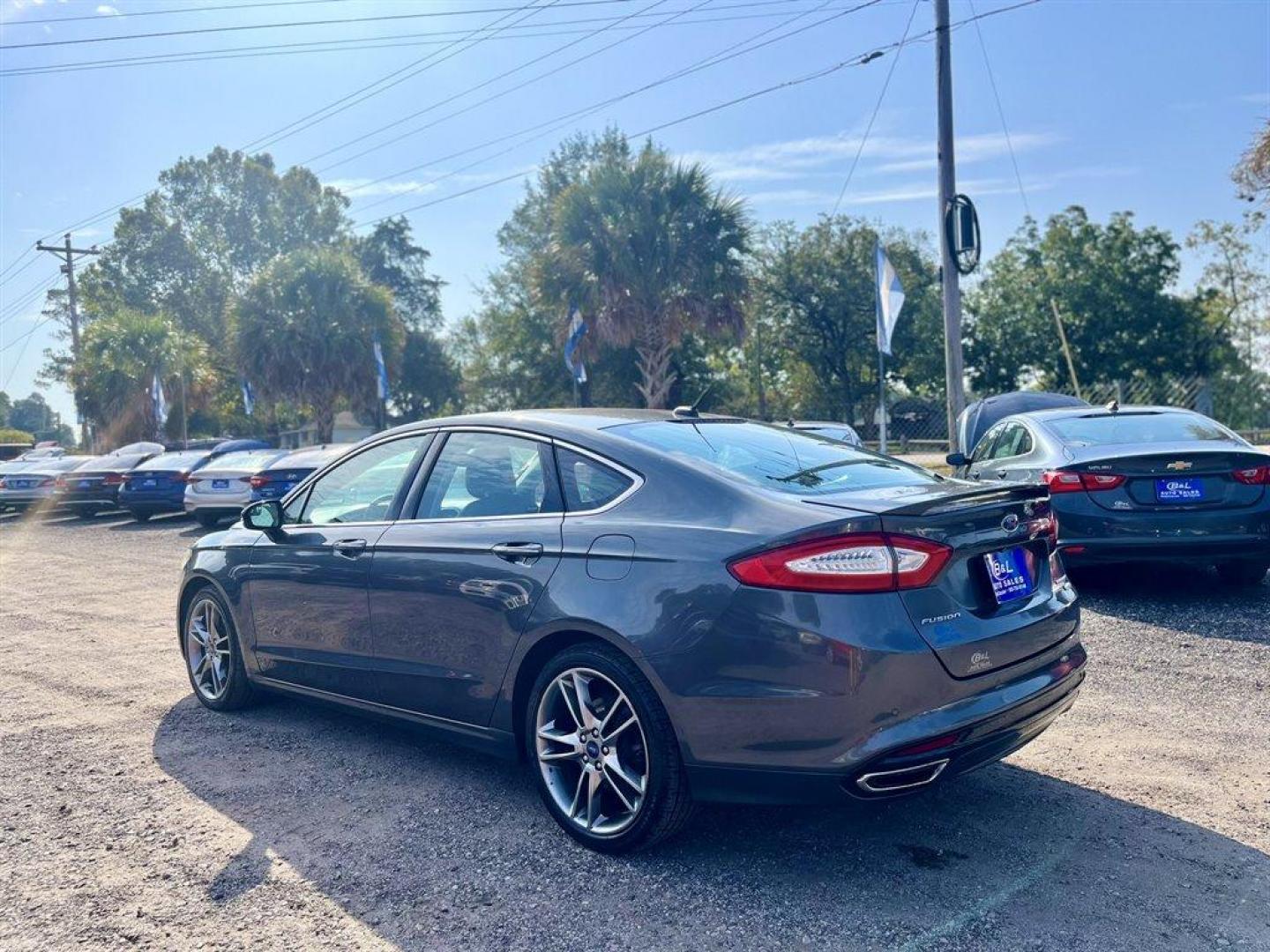 2015 Grey /Black Ford Fusion (3FA6P0K9XFR) with an 2.0l I-4 DI T/C Ecoboost engine, Automatic transmission, located at 745 East Steele Rd., West Columbia, SC, 29170, (803) 755-9148, 33.927212, -81.148483 - Special Internet Price! 2015 Ford Fusion Titanium with Bluetooth, Backup camera, Navigation, Sunroof, SIRIUS Satellite Radio, Remote Keyless Entry, Leather Interior, Rear 60-40 Folding Bench, Cruise Control with Steering Wheel Controls, Plus more! - Photo#1