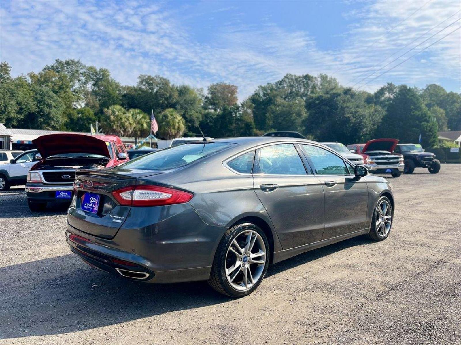 2015 Grey /Black Ford Fusion (3FA6P0K9XFR) with an 2.0l I-4 DI T/C Ecoboost engine, Automatic transmission, located at 745 East Steele Rd., West Columbia, SC, 29170, (803) 755-9148, 33.927212, -81.148483 - Special Internet Price! 2015 Ford Fusion Titanium with Bluetooth, Backup camera, Navigation, Sunroof, SIRIUS Satellite Radio, Remote Keyless Entry, Leather Interior, Rear 60-40 Folding Bench, Cruise Control with Steering Wheel Controls, Plus more! - Photo #2