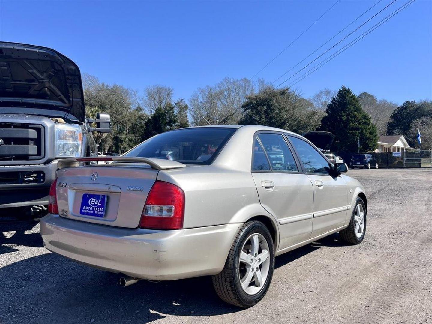 2002 Gold /Beige Mazda Protege (JM1BJ226021) with an 2.0l I-4 EFI Dohc 2.0l engine, 5 Speed Manual transmission, located at 745 East Steele Rd., West Columbia, SC, 29170, (803) 755-9148, 33.927212, -81.148483 - Special Internet Price! 2002 Mazda Protege with AM/FM stereo, Keyless remote, Air conditioning, Cruise control, Sunroof, Manual transmission, Cloth reclining front bucket seats, 60/40 split fold-down rear, Powered windows, Plus more! - Photo#2