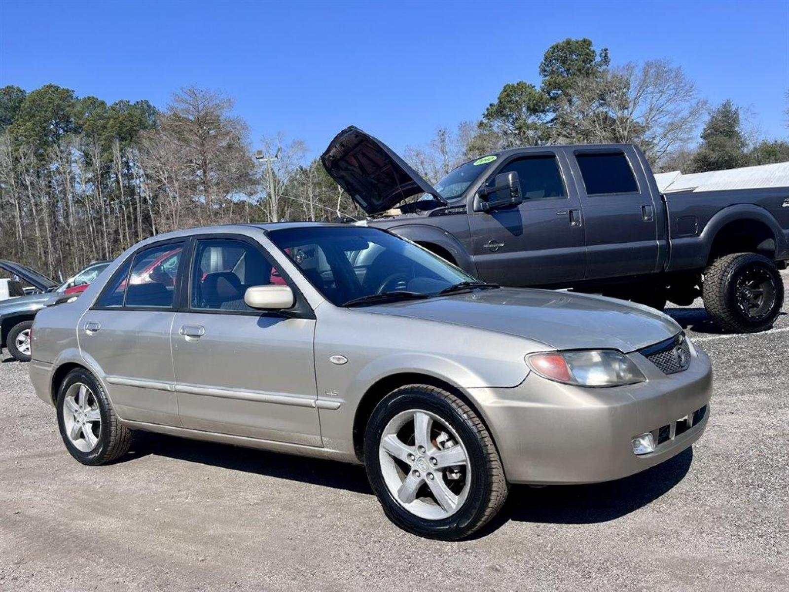 2002 Gold /Beige Mazda Protege (JM1BJ226021) with an 2.0l I-4 EFI Dohc 2.0l engine, 5 Speed Manual transmission, located at 745 East Steele Rd., West Columbia, SC, 29170, (803) 755-9148, 33.927212, -81.148483 - Special Internet Price! 2002 Mazda Protege with AM/FM stereo, Keyless remote, Air conditioning, Cruise control, Sunroof, Manual transmission, Cloth reclining front bucket seats, 60/40 split fold-down rear, Powered windows, Plus more! - Photo #3