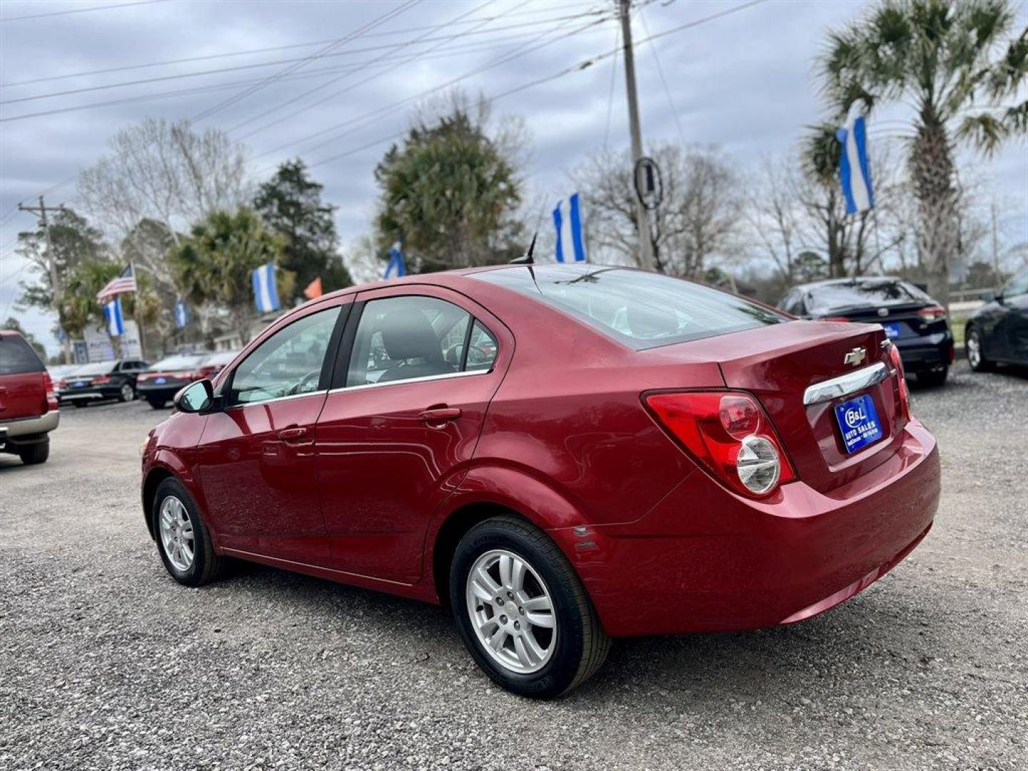 2013 Red /Black Chevrolet Sonic (1G1JD5SB7D4) with an 1.4l I-4 MFI Dohc T/C 1.4 engine, Manual transmission, located at 745 East Steele Rd., West Columbia, SC, 29170, (803) 755-9148, 33.927212, -81.148483 - Special Internet Price! 2013 Chevrolet Sonic LT with Bluetooth, Sirius XM Satellite Radio, Cruise control, Air conditioning, Remote keyless entry, Cloth interior, Powered windows, Powered door locks, Plus more! - Photo#1