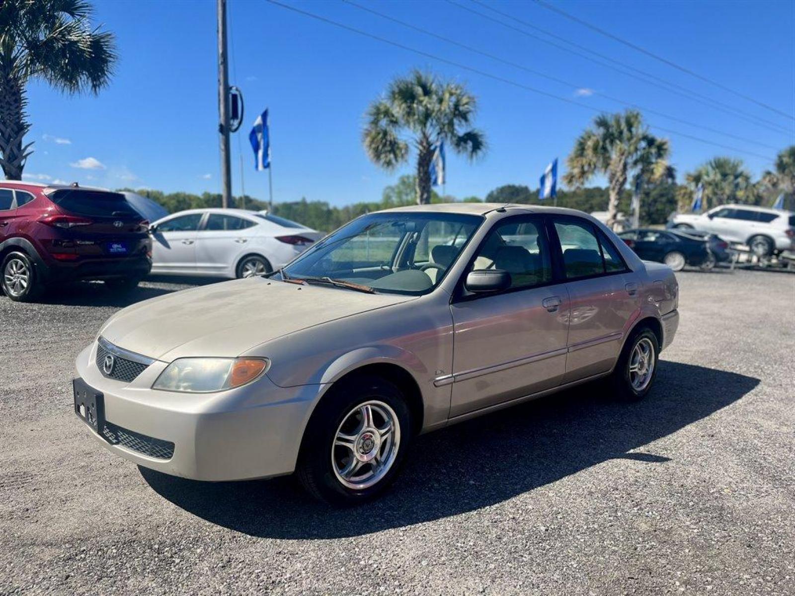 2001 Gold /Tan Mazda Protege (JM1BJ222210) with an 1.6l I-4 MPI Dohc 1.6l engine, Manual transmission, located at 745 East Steele Rd., West Columbia, SC, 29170, (803) 755-9148, 33.927212, -81.148483 - Special Internet Price! 2001 Mazda Protege with AM/FM stereo, Keyless remote, Air conditioning, Cruise control, Sunroof, Manual transmission, Cloth reclining front bucket seats, 60/40 split fold-down rear, Powered windows, Plus more! - Photo #0